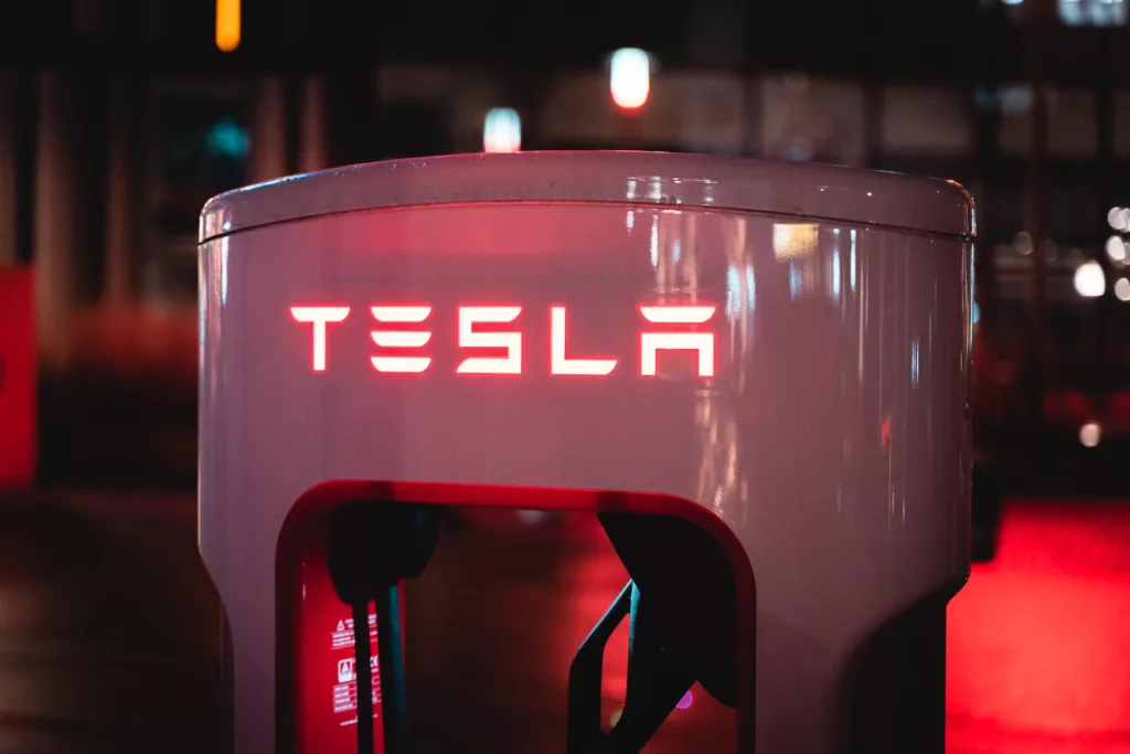 a red tesla logo on a white machine